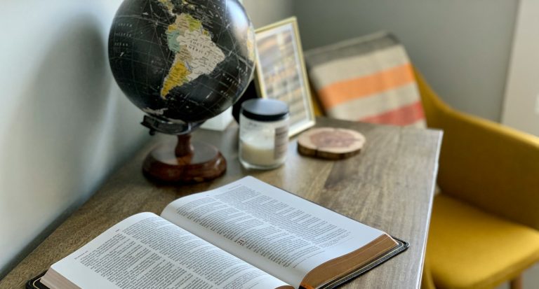 opened book on brown wooden table